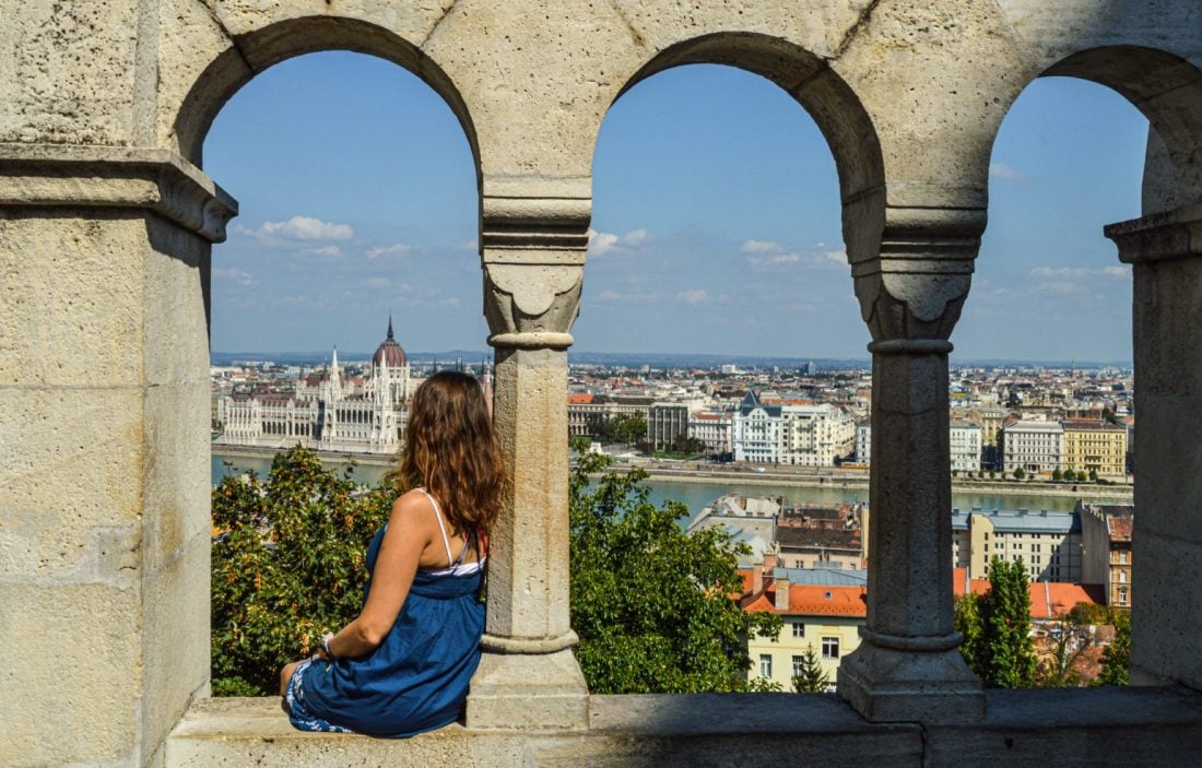 Women sitting on ledge overlooking Budapest